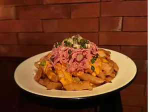 Papas fritas con cheddar de El Creyente Bar